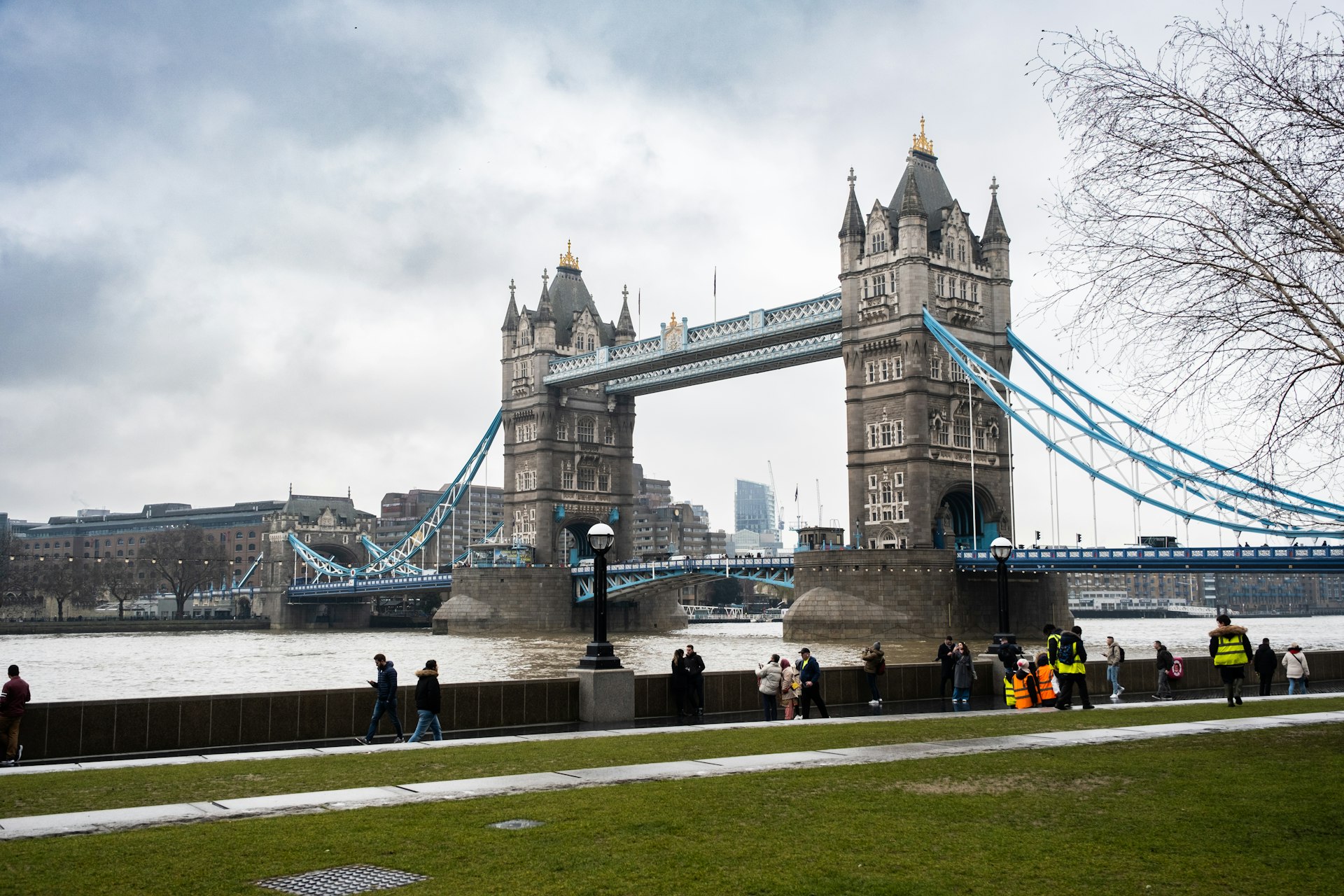 a group of people standing in front of a bridge